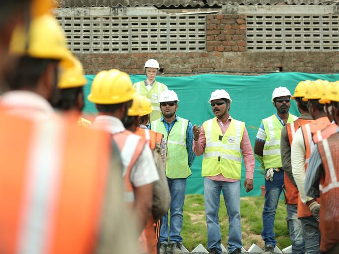 Employees at daily site meeting