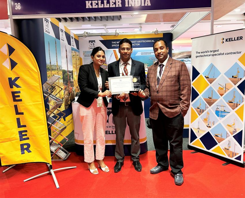 Three Human Resource professionals holding an award