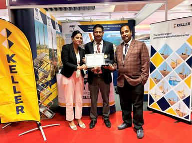 Three Human Resource professionals holding an award