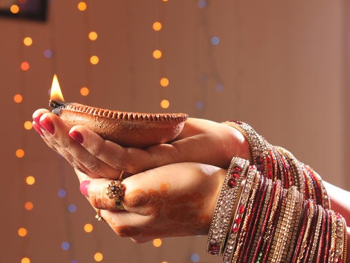 Lady holding candle for Diwali